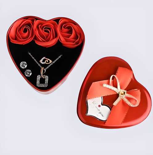 Heart-shaped jewelry box with red rose decorations, necklace, earrings, and a small white shoe with a bow.